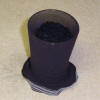 Activated carbon has been placed inside the panty hose and is ready to be tied.